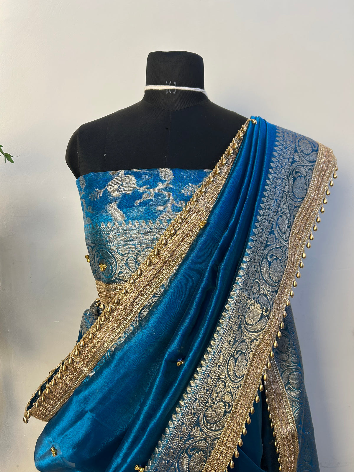 Peacock blue ghungroo saree gold bells close-up