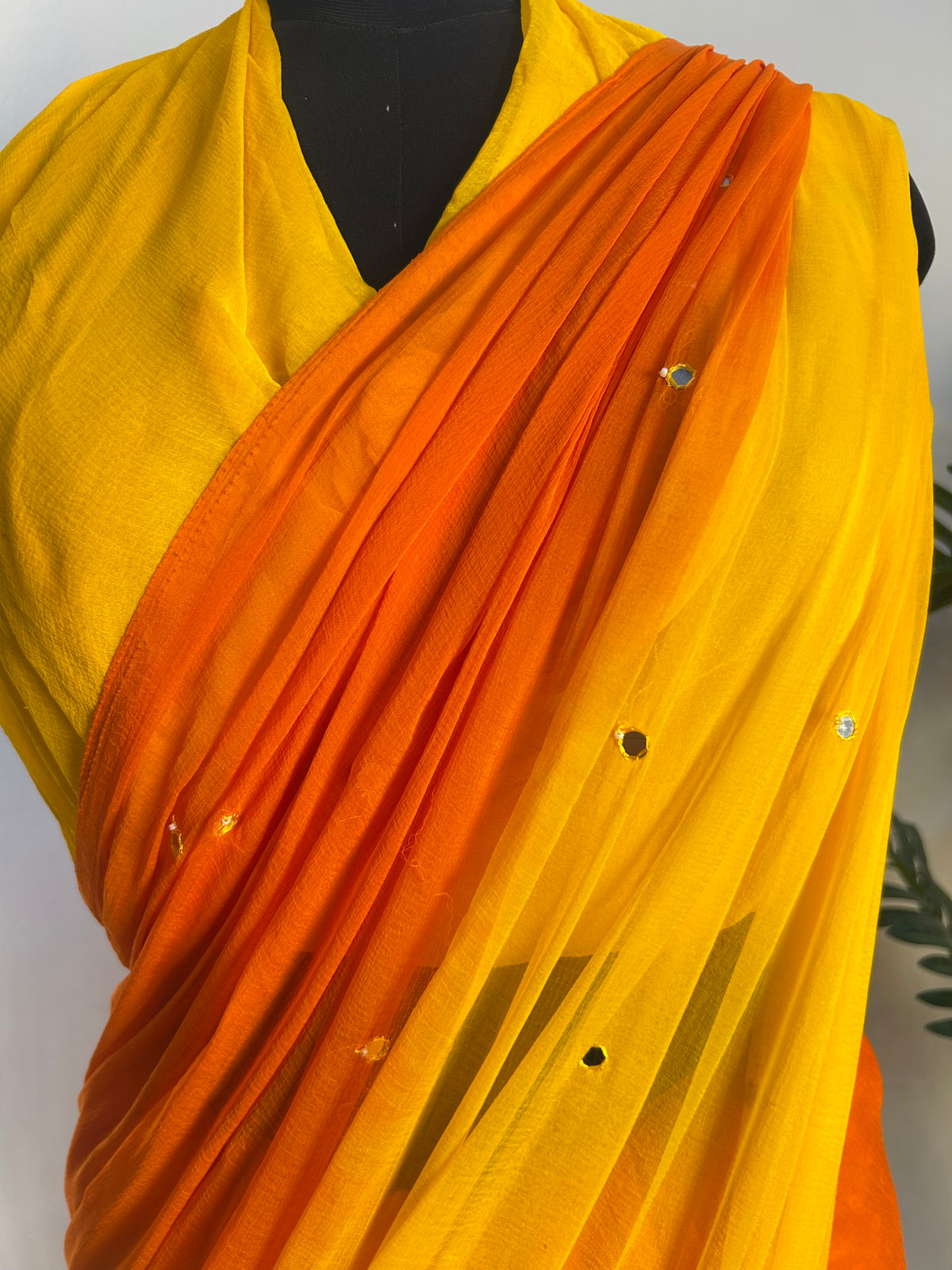 Orange-yellow ombre saree mirror embellishment close-up