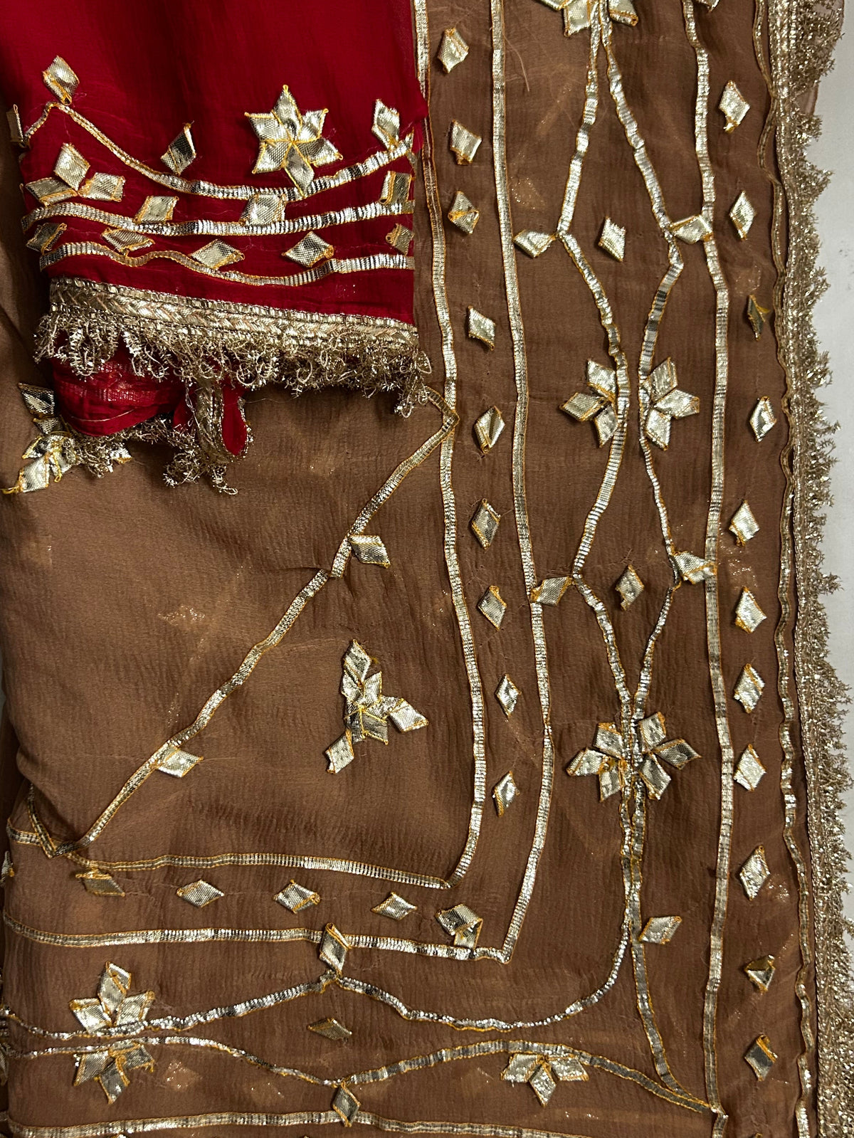 Cheeku gota patti chiffon saree with red contrast blouse, draped view