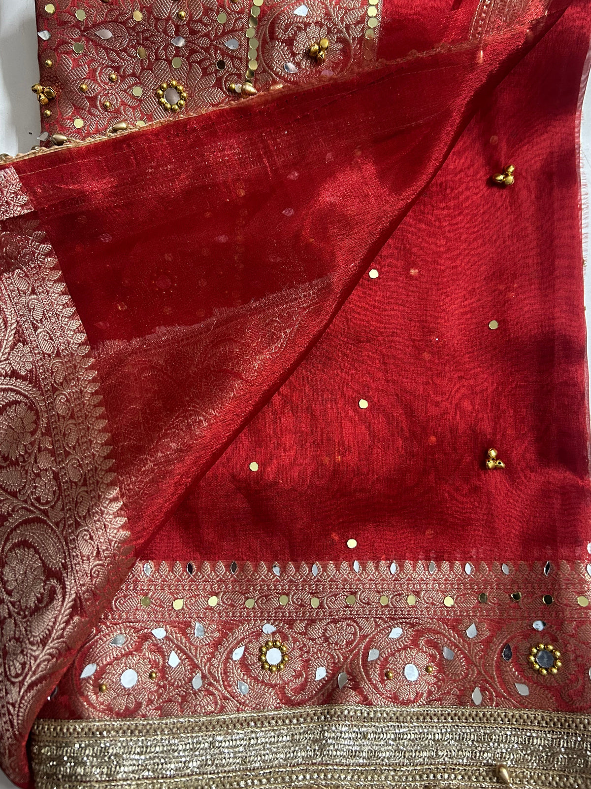 Red Banarasi saree ghungroo bell border close-up