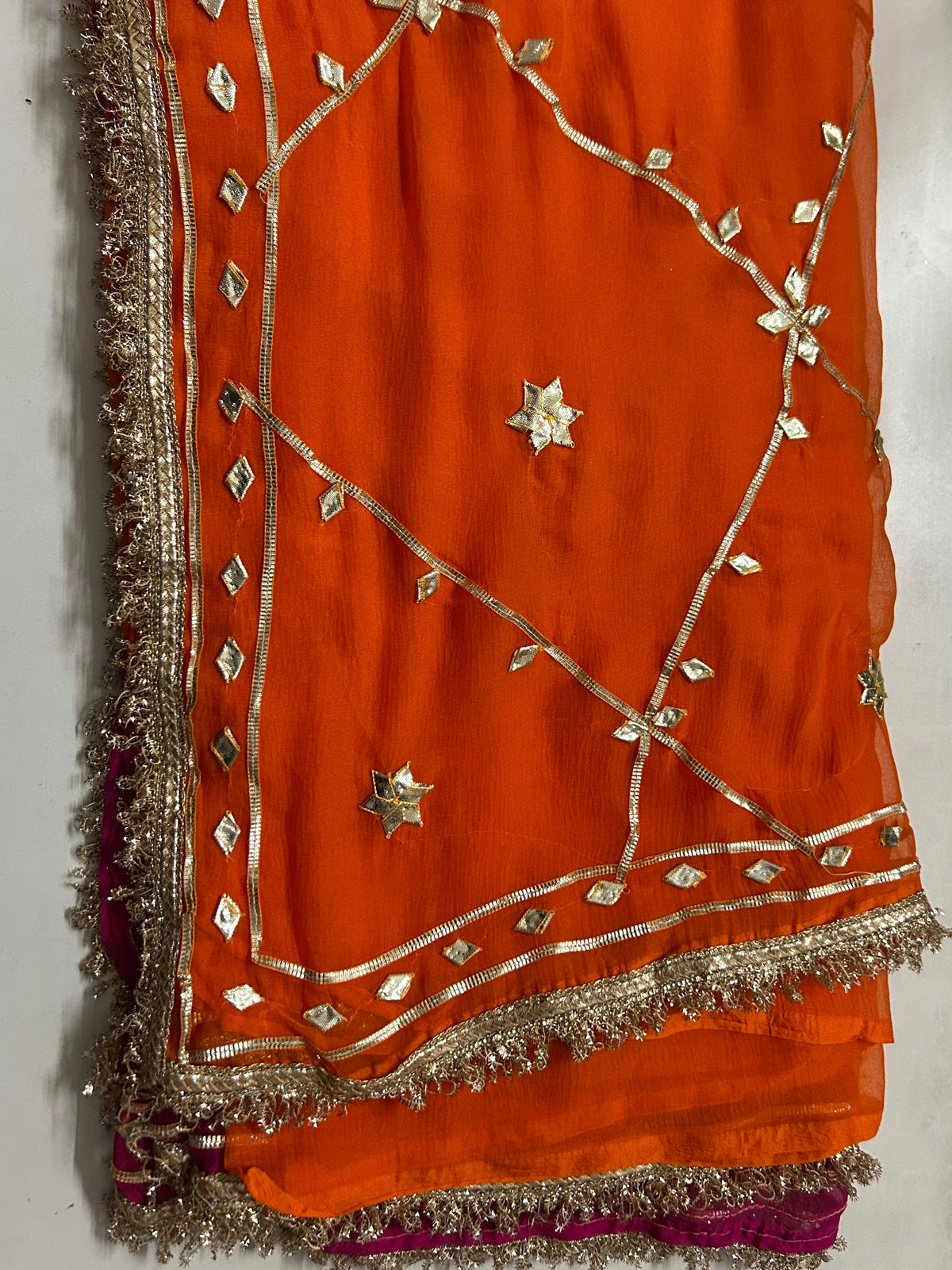 Orange-pink ombre chiffon saree mirror-dotted gota lace border
